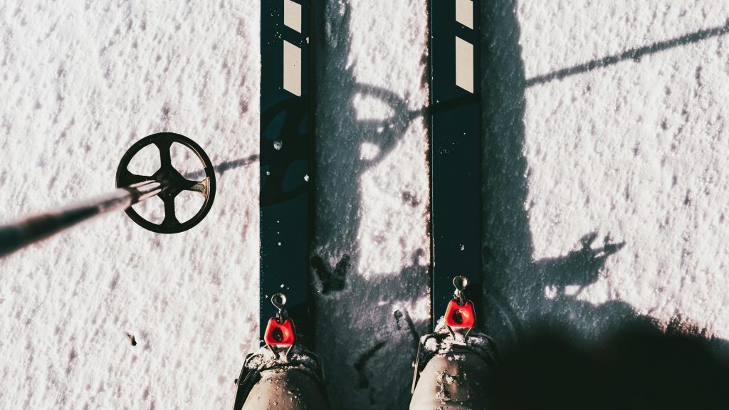 Close-up of cross-country skis and pole on snow during a sunny winter day in St. Martin am Tennengebirge