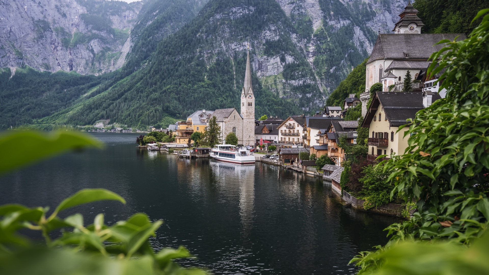 Famous lakeside view of Hallstatt village with church and mountains in SalzburgerLand, Austria