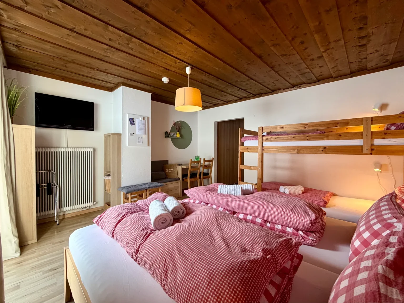 Bedroom with wooden furnishings in Room 10 at Hotel Alpenhof