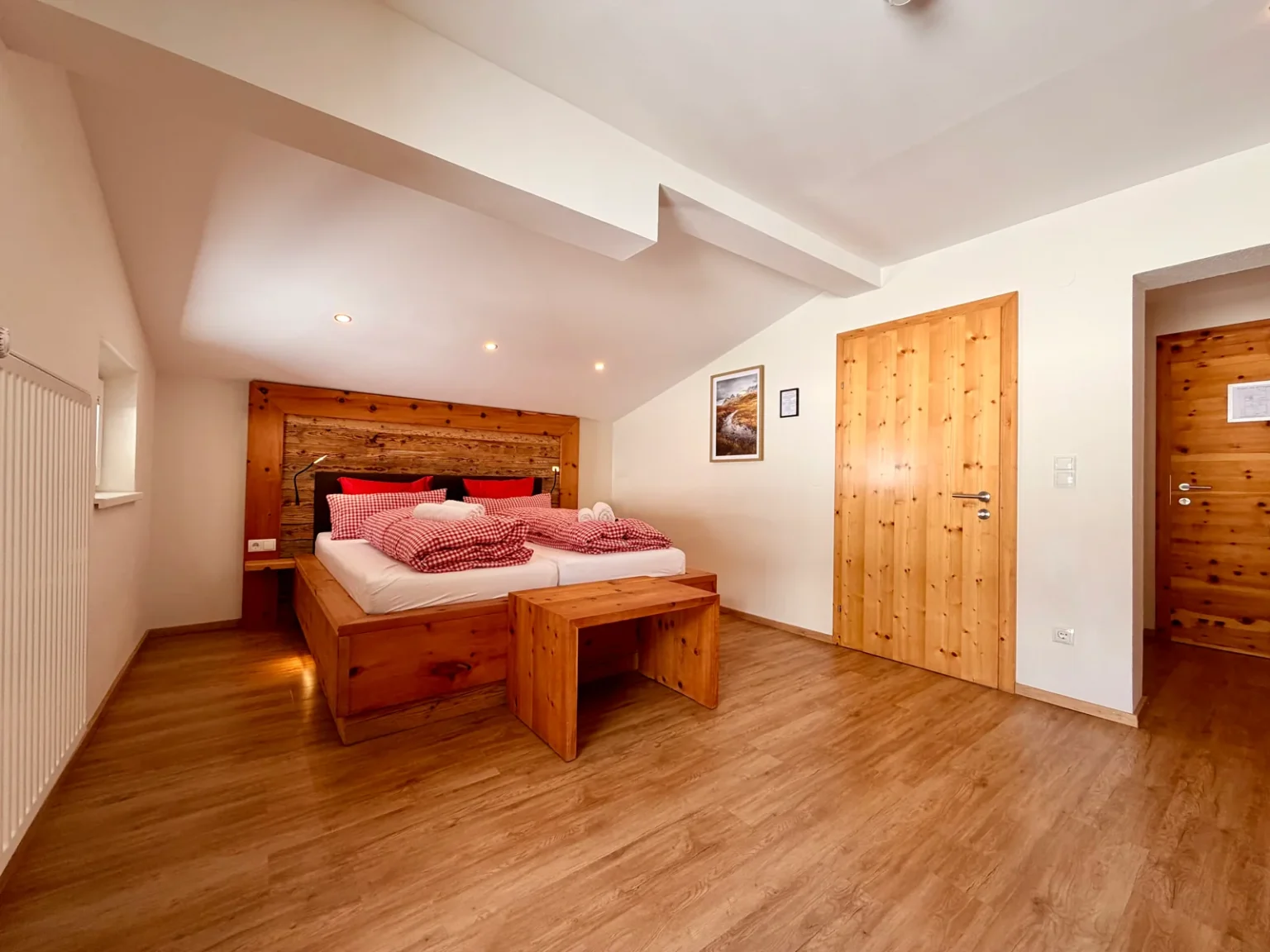 Bedroom with wooden furnishings in Room 12 at Hotel Alpenhof