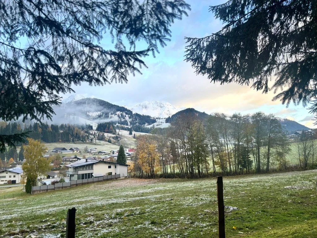 Het dorp tussen takken met een dun laagje sneeuw